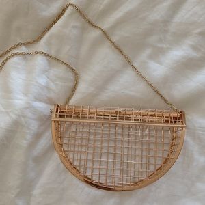 Half moon cage clutch bag